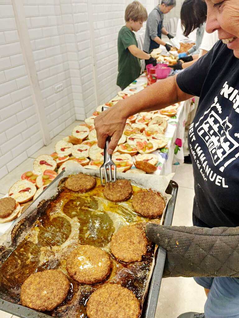 Men and women struggling with homelessness and drug addictions receive a hot meal